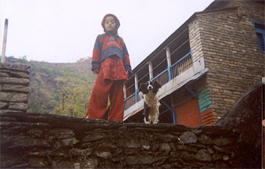 Kind in einem traditionellen Steinhaus am Fusse des Pokarah-Mountains